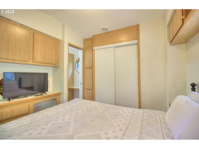 a bedroom with a bed and a flat screen tv