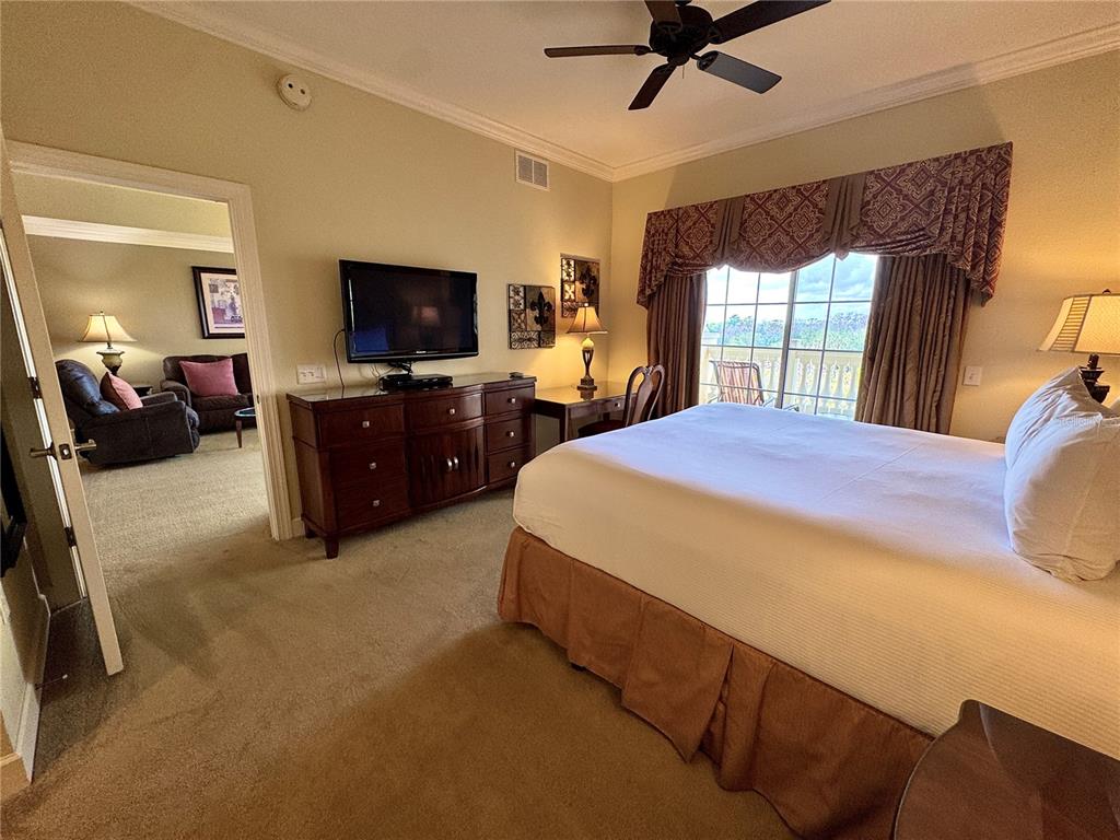 1350 Centre Ct Ridge Drive, Unit 401 Reunion, FL 34747 - Photo 24 of 32 a bedroom with a bed and a flat screen tv