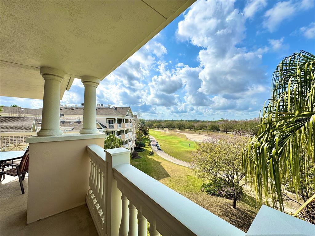 1350 Centre Ct Ridge Drive, Unit 401 Reunion, FL 34747 - Photo 30 of 32 a view of a kitchen with furniture and a floor to ceiling window