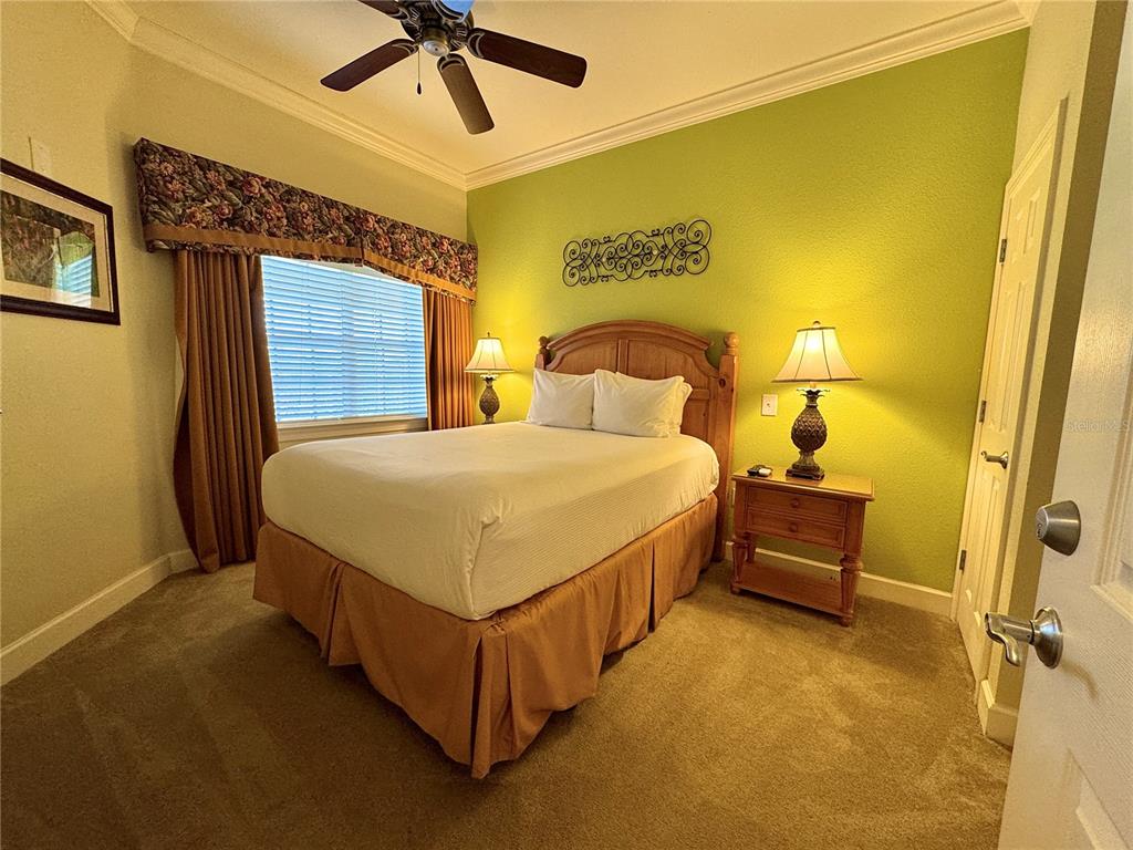 1350 Centre Ct Ridge Drive, Unit 401 Reunion, FL 34747 - Photo 3 of 32 a bedroom with a bed and dresser