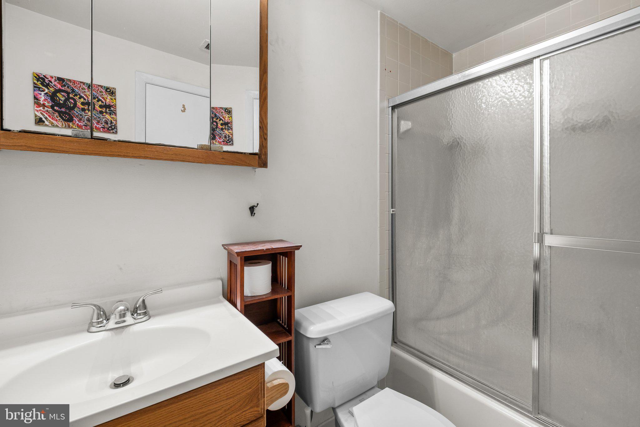 1763 Columbia Road Northwest, Unit 510 Washington, DC 20009 - Photo 12 of 17 a bathroom with a sink toilet and shower