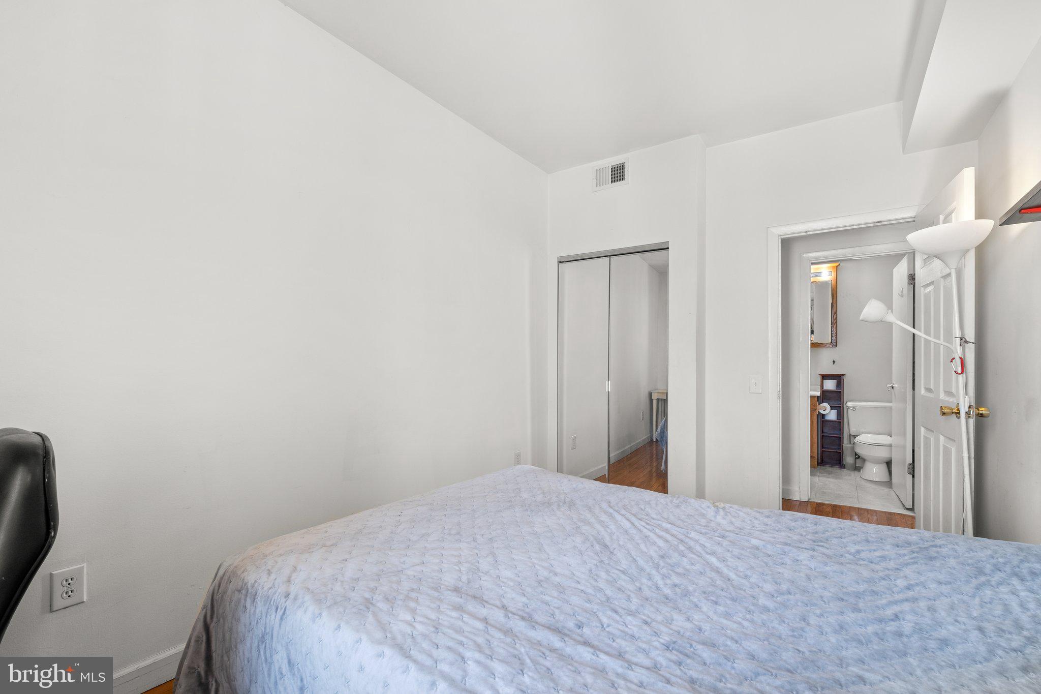 1763 Columbia Road Northwest, Unit 510 Washington, DC 20009 - Photo 15 of 17 a bedroom with a bed and a bathroom