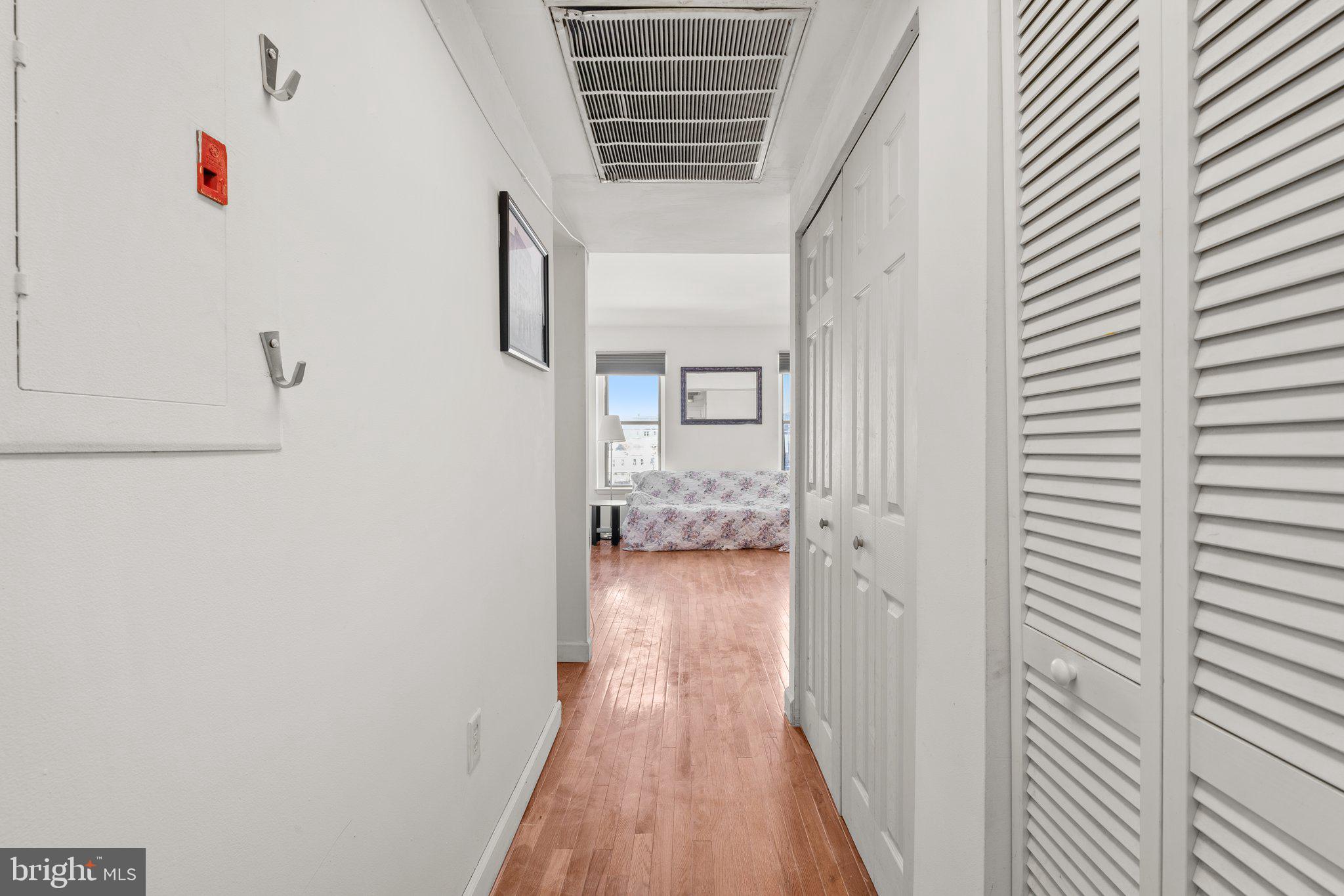1763 Columbia Road Northwest, Unit 510 Washington, DC 20009 - Photo 3 of 17 a view of a hallway with wooden floor and staircase