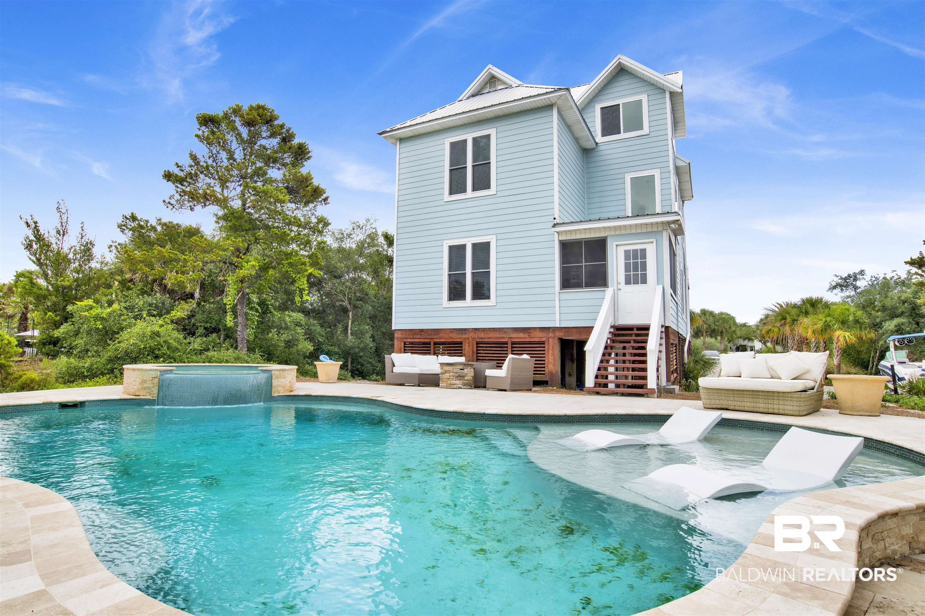 30351 River Road Orange Beach, AL 36561 - Photo 6 of 44 Backyard oasis featuring a freeform pool with integrated lounge areas and a waterfall spa