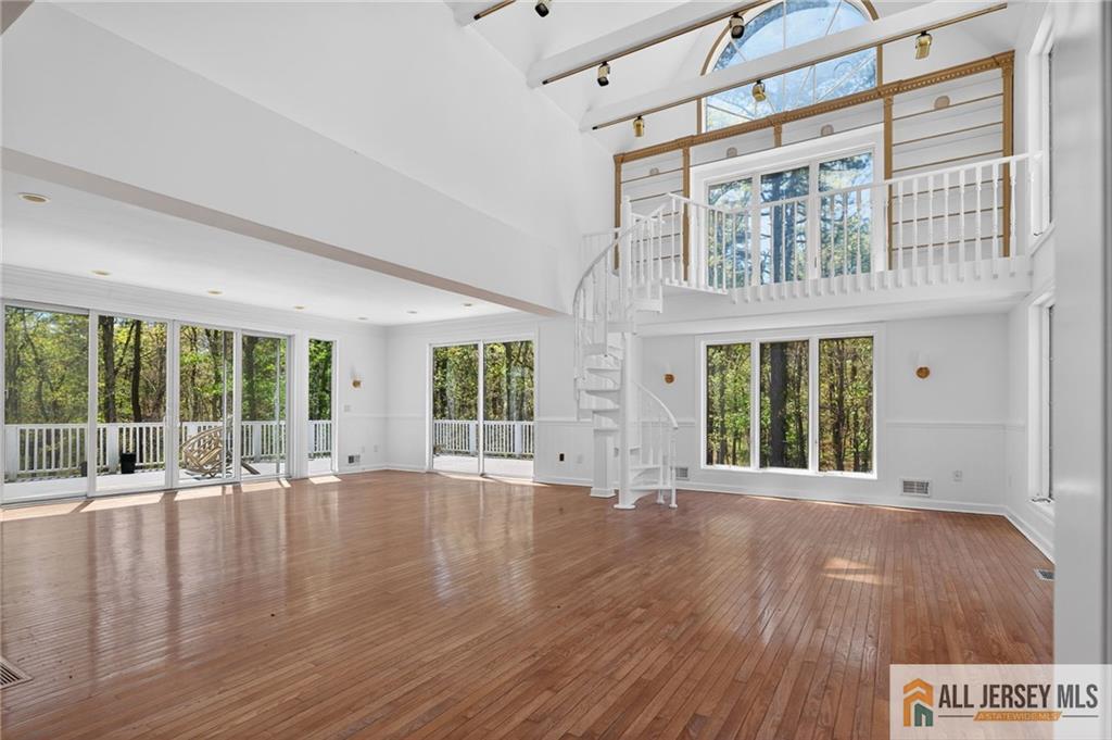 381 Monmouth Road Freehold, NJ 07728 - Photo 35 of 63 a view of an room with wooden floor and windows