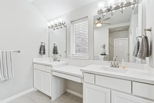 a bathroom with a sink double vanity and a mirror