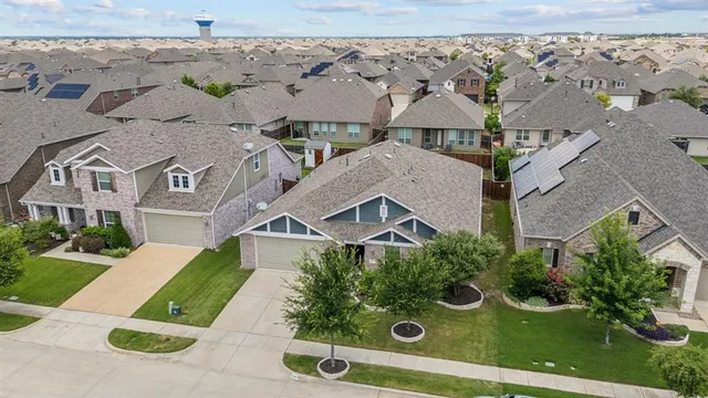 an aerial view of a house with yard
