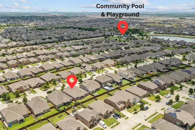 an aerial view of a house with a garden and mountain view