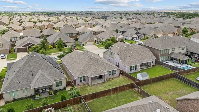 an aerial view of a house with a yard