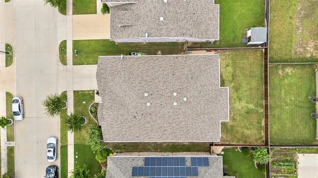 a street sign sitting on top of a park next to a building