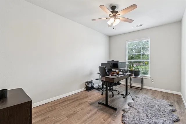 a view of a workspace with furniture and a window