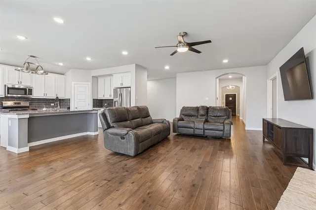a living room with furniture and a wooden floor