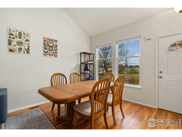 a view of a dining room with furniture wooden floor and chandelier