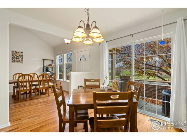a kitchen with granite countertop a sink a stove top oven and wooden cabinetry