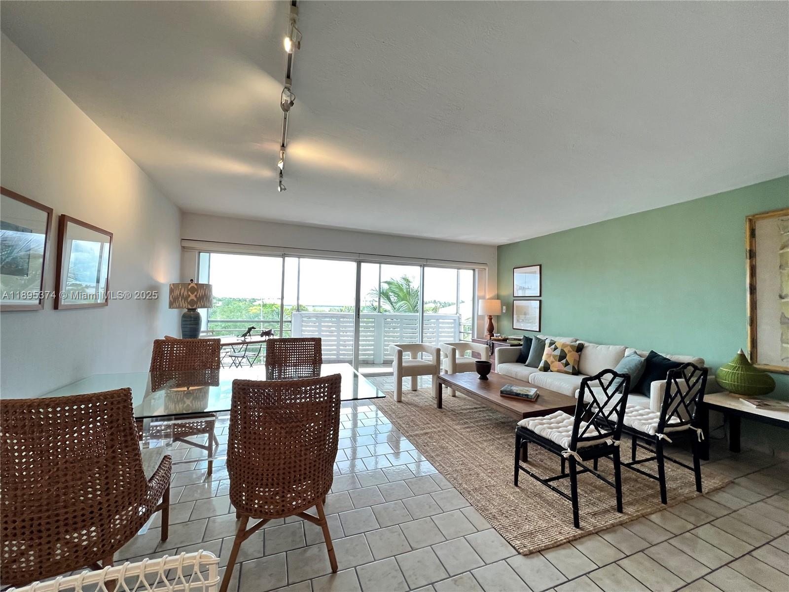 555 Crandon Boulevard, Unit 53 Key Biscayne, FL 33149 - Photo 11 of 33 a living room with furniture and a floor to ceiling window