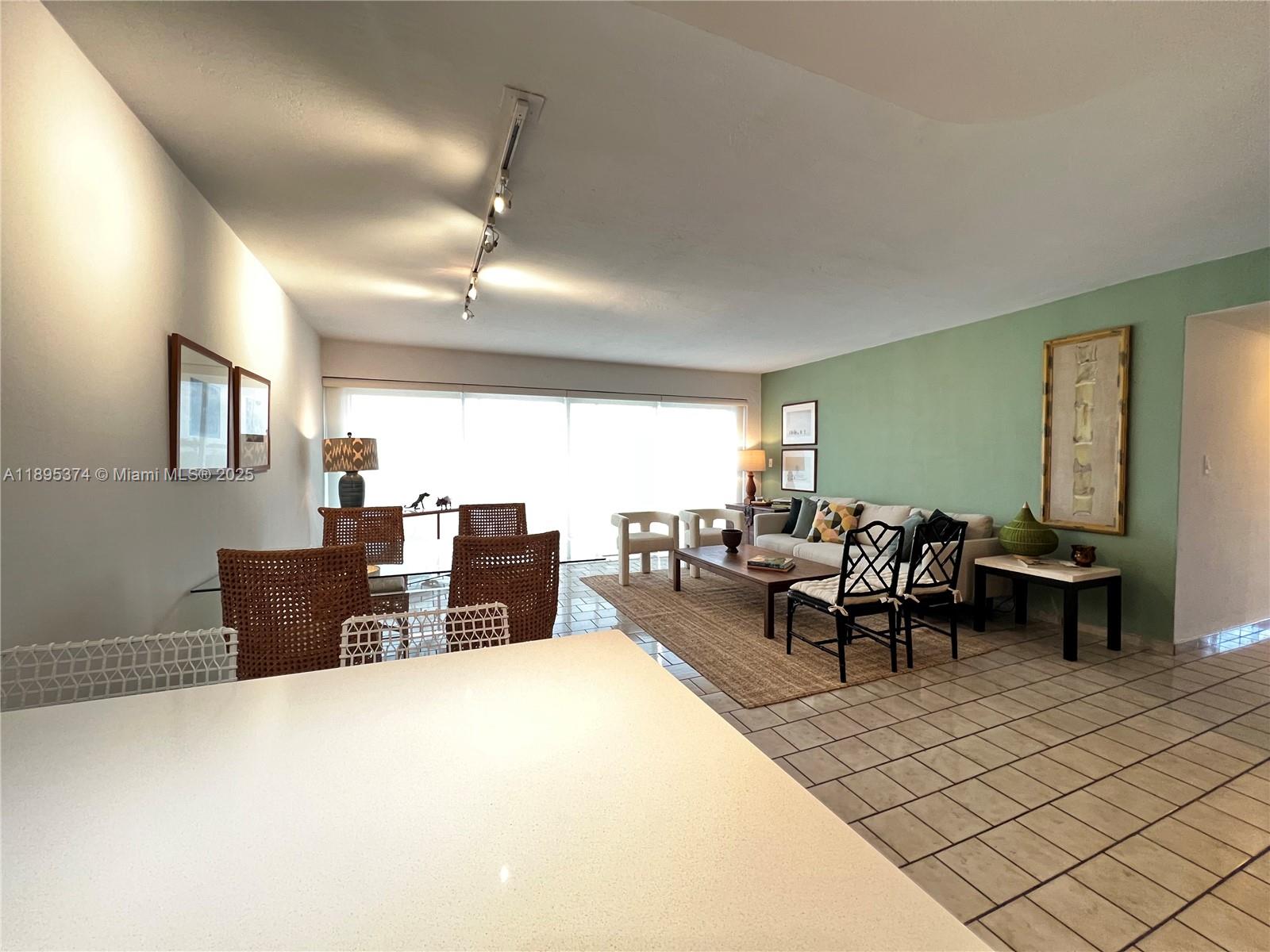 555 Crandon Boulevard, Unit 53 Key Biscayne, FL 33149 - Photo 12 of 33 a living room with furniture and a large window