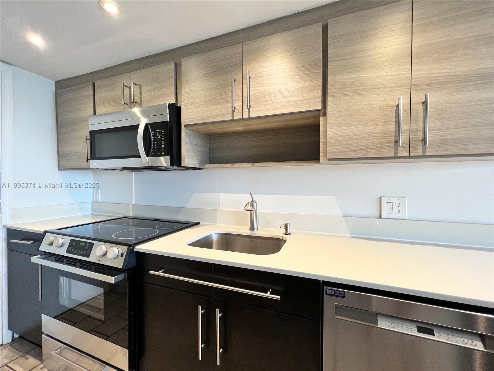 555 Crandon Boulevard, Unit 53 Key Biscayne, FL 33149 - Photo 16 of 33 a kitchen with a sink and cabinets