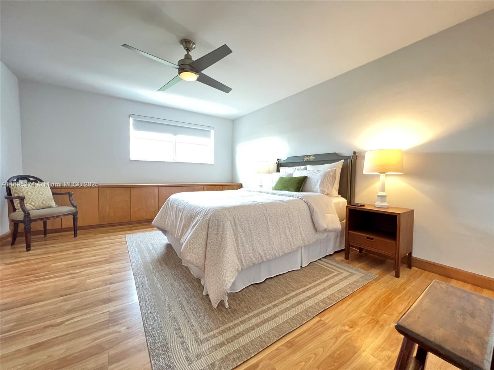 555 Crandon Boulevard, Unit 53 Key Biscayne, FL 33149 - Photo 17 of 33 a bed room with a bed and a chair