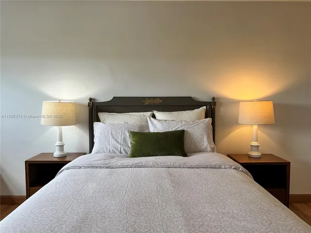a bedroom with a bed and a lamp
