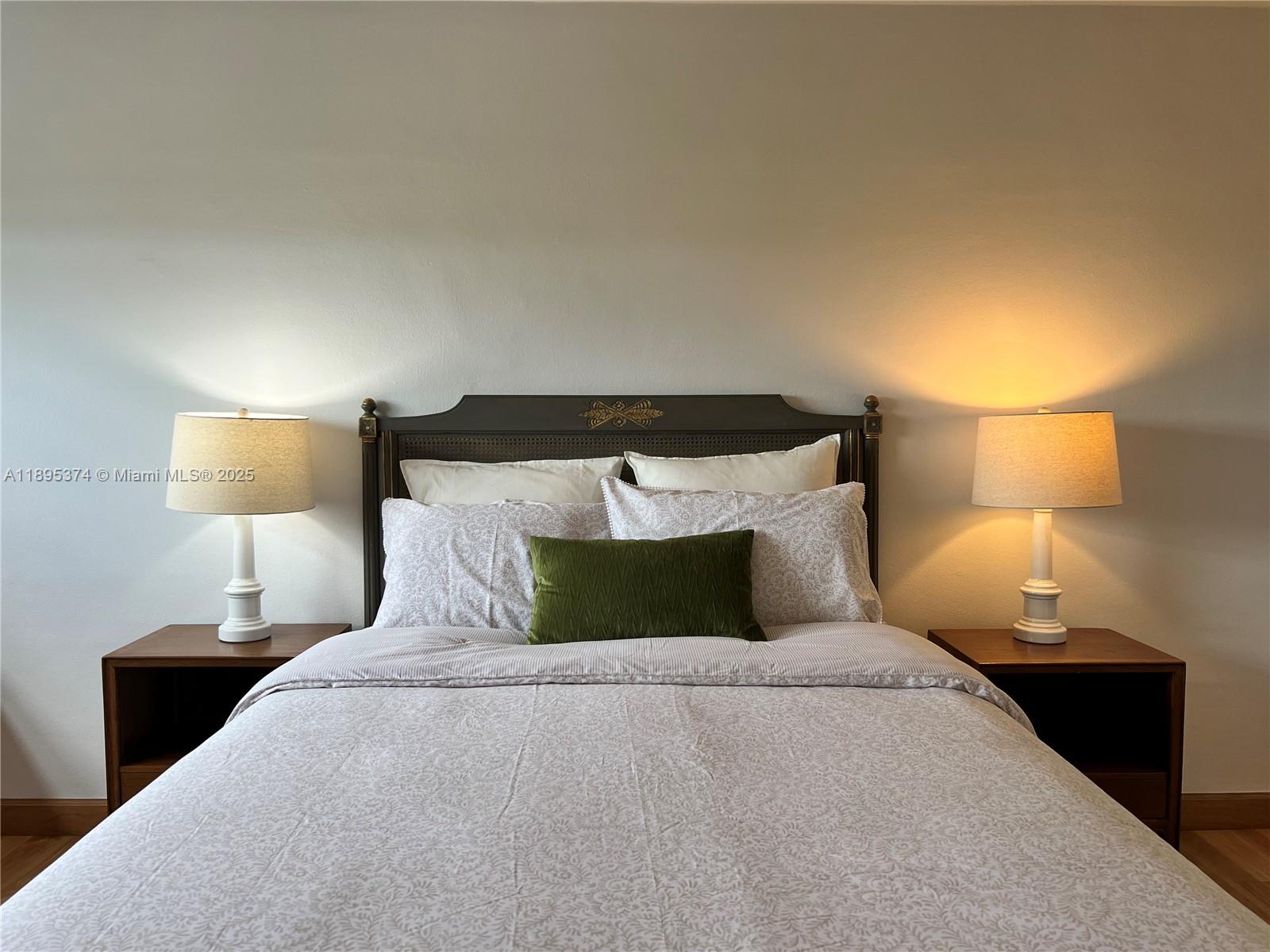 555 Crandon Boulevard, Unit 53 Key Biscayne, FL 33149 - Photo 19 of 33 a bedroom with a bed and a lamp