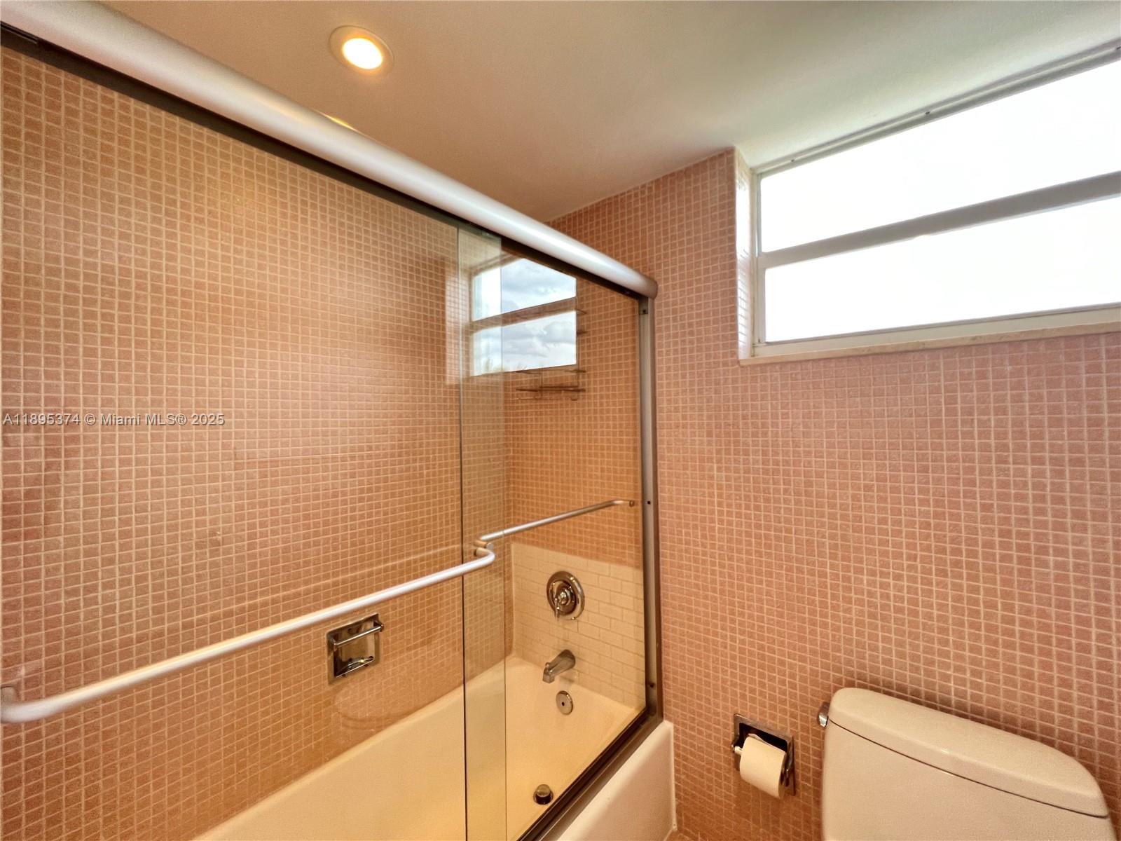 555 Crandon Boulevard, Unit 53 Key Biscayne, FL 33149 - Photo 22 of 33 a bathroom with a toilet and a shower