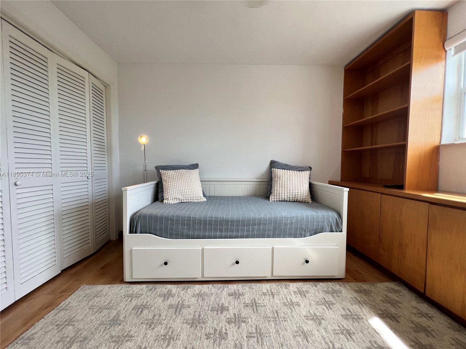 555 Crandon Boulevard, Unit 53 Key Biscayne, FL 33149 - Photo 25 of 33 a bedroom with a bed and window