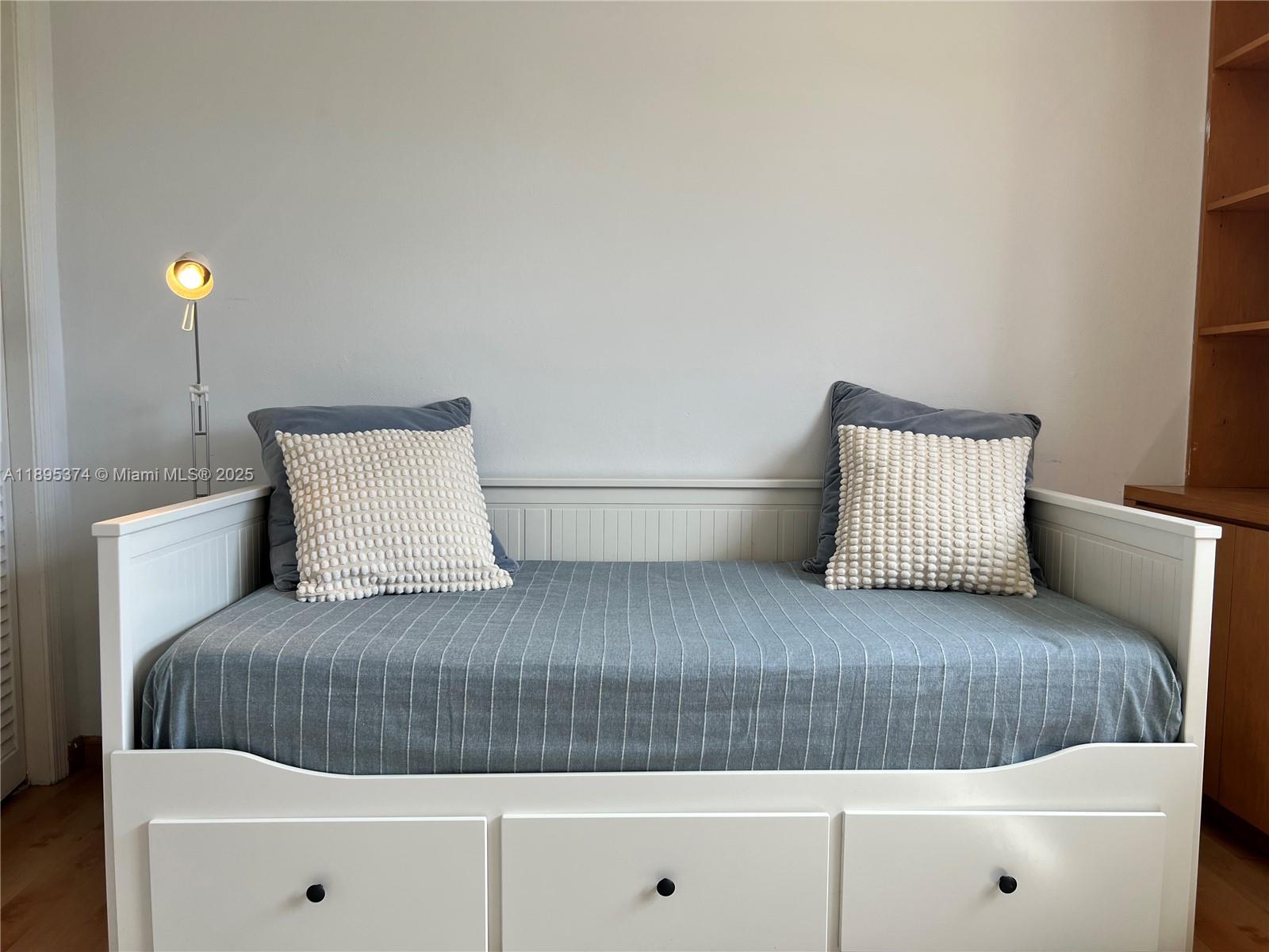 555 Crandon Boulevard, Unit 53 Key Biscayne, FL 33149 - Photo 26 of 33 a bedroom with a bed and cabinet