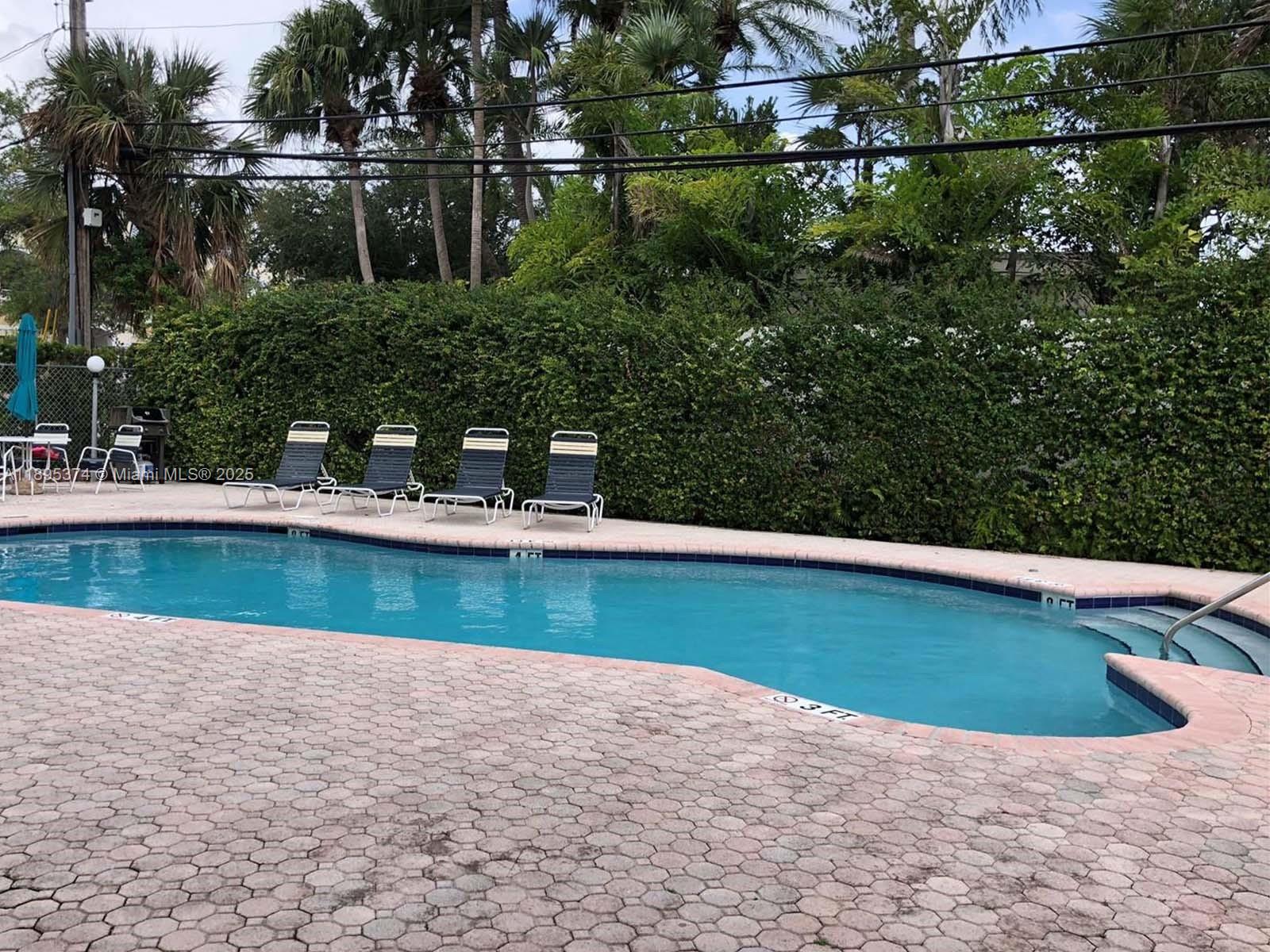 555 Crandon Boulevard, Unit 53 Key Biscayne, FL 33149 - Photo 32 of 33 a view of a house with a yard