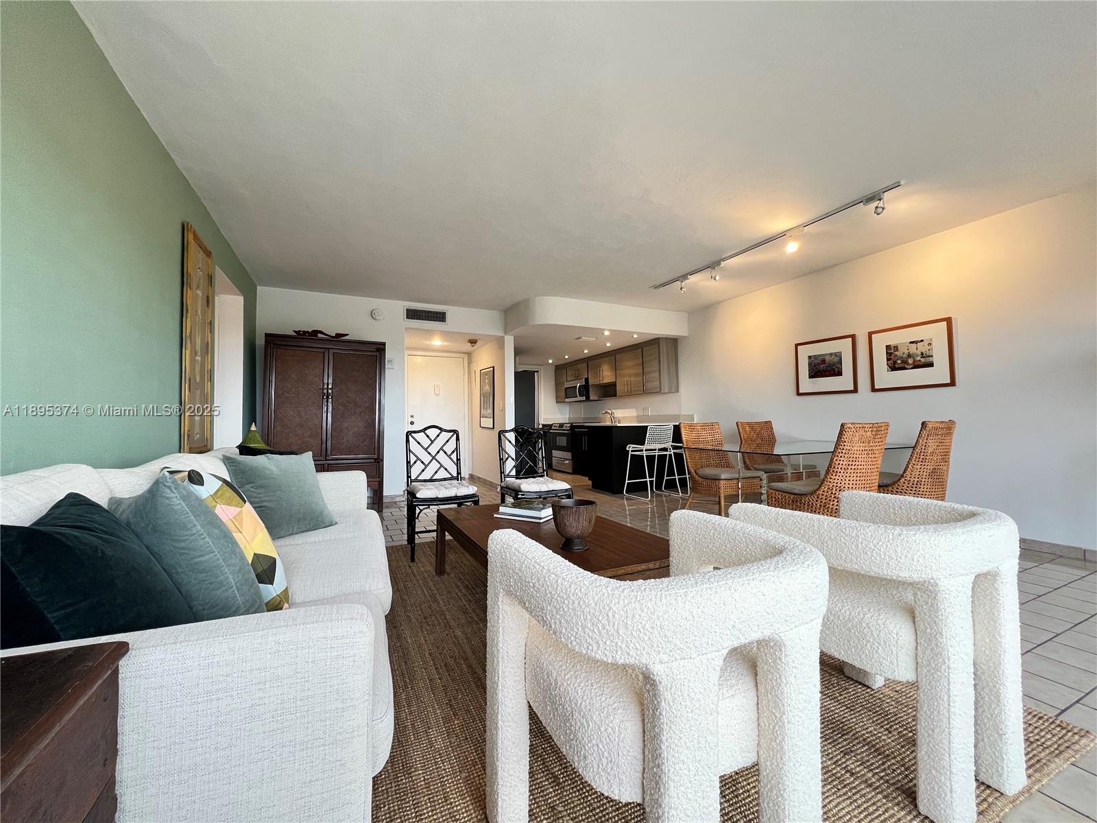 555 Crandon Boulevard, Unit 53 Key Biscayne, FL 33149 - Photo 6 of 33 a living room with furniture a large window and kitchen view