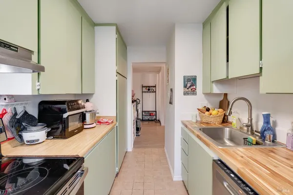 a kitchen with kitchen island a sink stove and cabinets