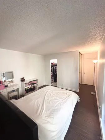a bedroom with bed and cabinets