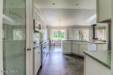a kitchen with counter top space and windows
