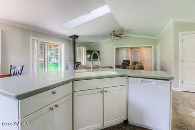 a kitchen with sink cabinets and a wooden floor