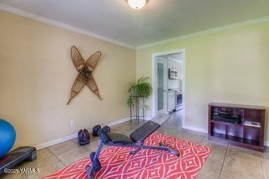 a bedroom with a bed and a potted plant