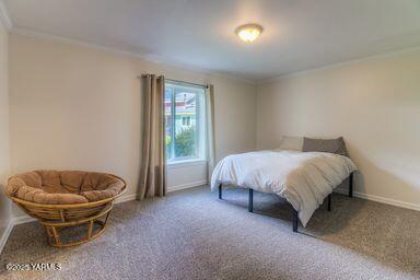 121 Rattlesnake Lane Naches, WA 98937 - Photo 20 of 45 a spacious bedroom with a bed and a chair