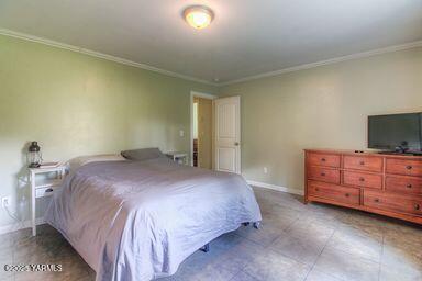 121 Rattlesnake Lane Naches, WA 98937 - Photo 23 of 45 a bedroom with a bed and flat screen tv