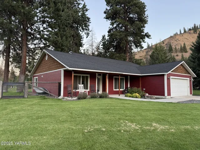 a front view of house with yard and green space