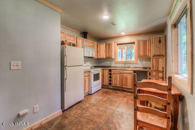 121 Rattlesnake Lane Naches, WA 98937 - Photo 32 of 45 a kitchen with white cabinets and white appliances
