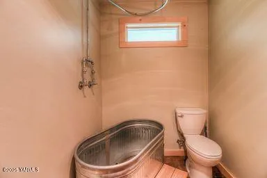 a white toilet sitting next to a shower