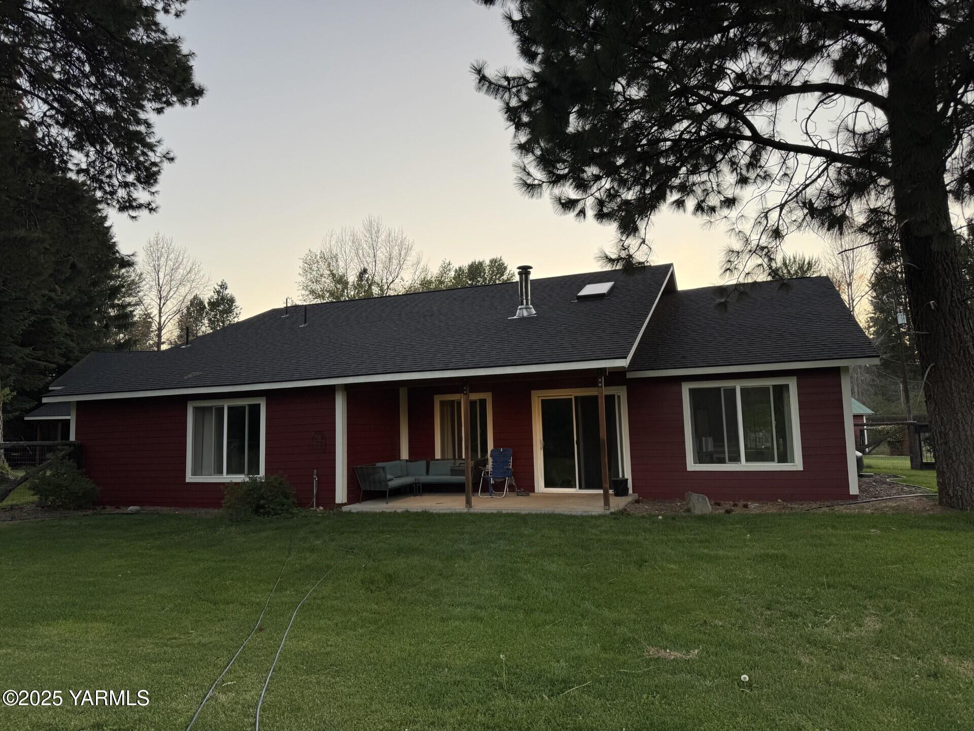 121 Rattlesnake Lane Naches, WA 98937 - Photo 4 of 45 a front view of a house with a garden