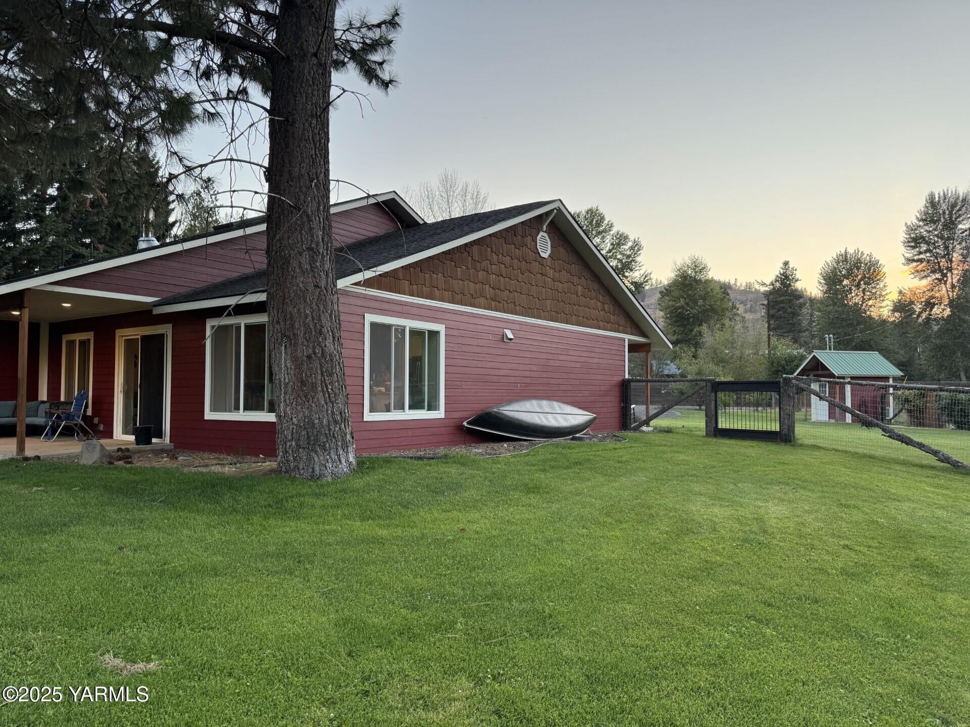121 Rattlesnake Lane Naches, WA 98937 - Photo 5 of 45 a front view of a house with a garden
