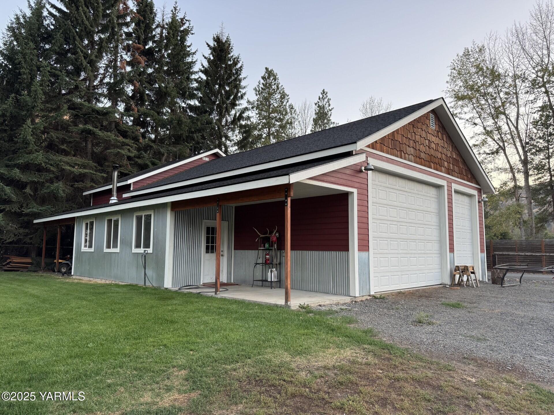 121 Rattlesnake Lane Naches, WA 98937 - Photo 6 of 45 a view of a house with a yard and garage