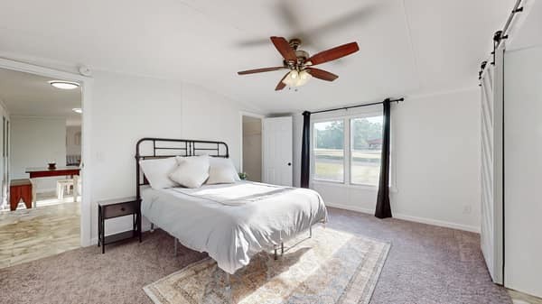 1051 Brandon Hollow Road Lynchburg, TN 37352 - Photo 13 of 36 a bedroom with a large bed and a window