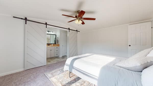 1051 Brandon Hollow Road Lynchburg, TN 37352 - Photo 15 of 36 a bedroom with a bed and a ceiling fan