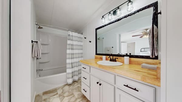 1051 Brandon Hollow Road Lynchburg, TN 37352 - Photo 17 of 36 a bathroom with a granite countertop sink mirror bathtub and shower