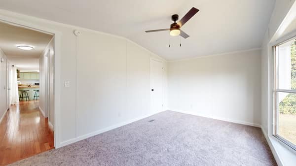 1051 Brandon Hollow Road Lynchburg, TN 37352 - Photo 19 of 36 an empty room with wooden floor and windows