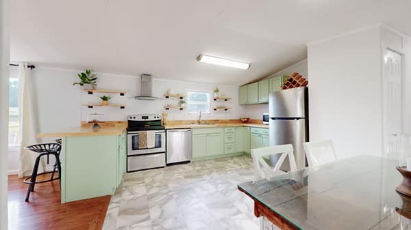 1051 Brandon Hollow Road Lynchburg, TN 37352 - Photo 26 of 36 a kitchen with a refrigerator and a stove top oven