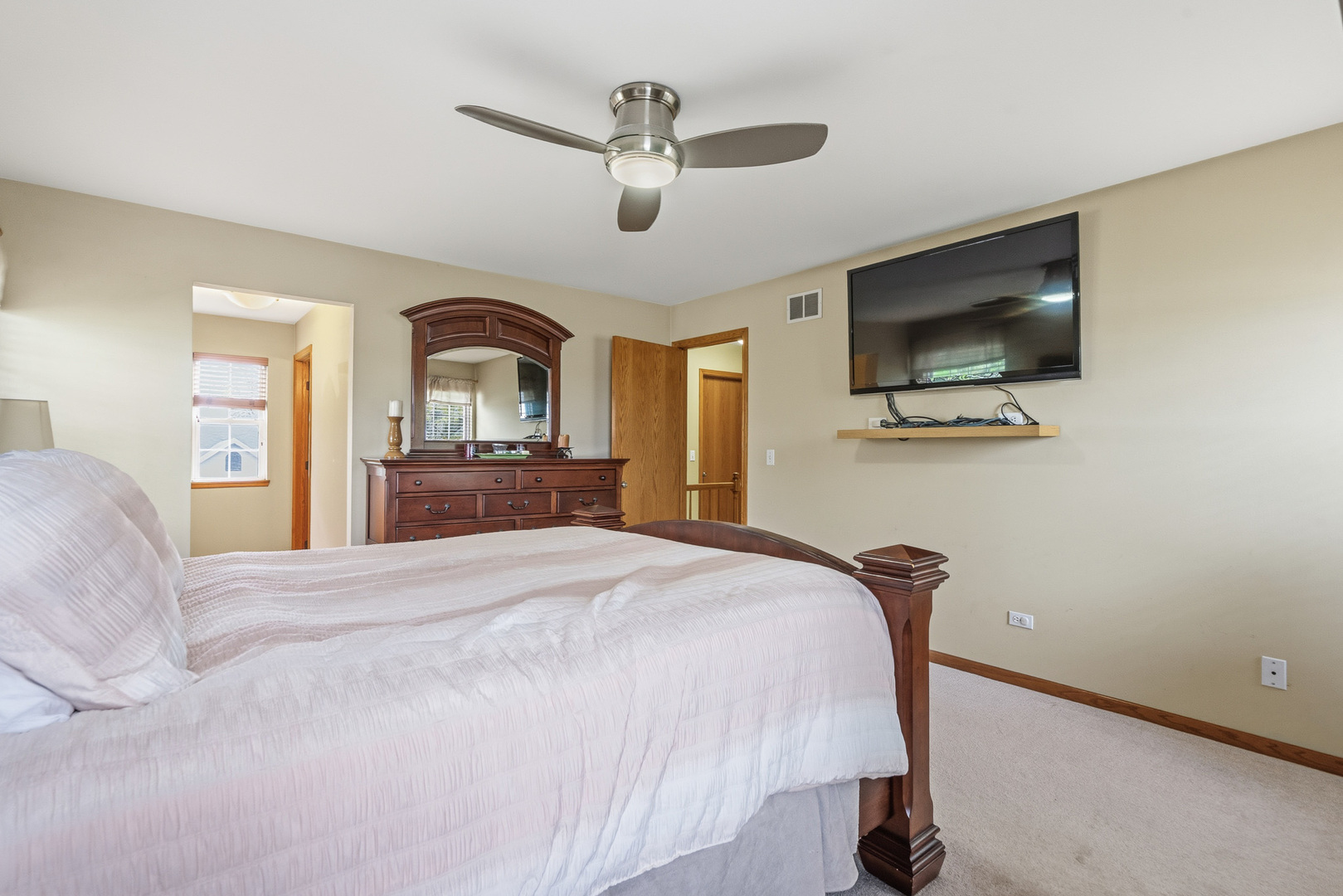 16719 South Sunset Ridge Court Lockport, IL 60441 - Photo 14 of 31 a bedroom with a bed and a flat screen tv