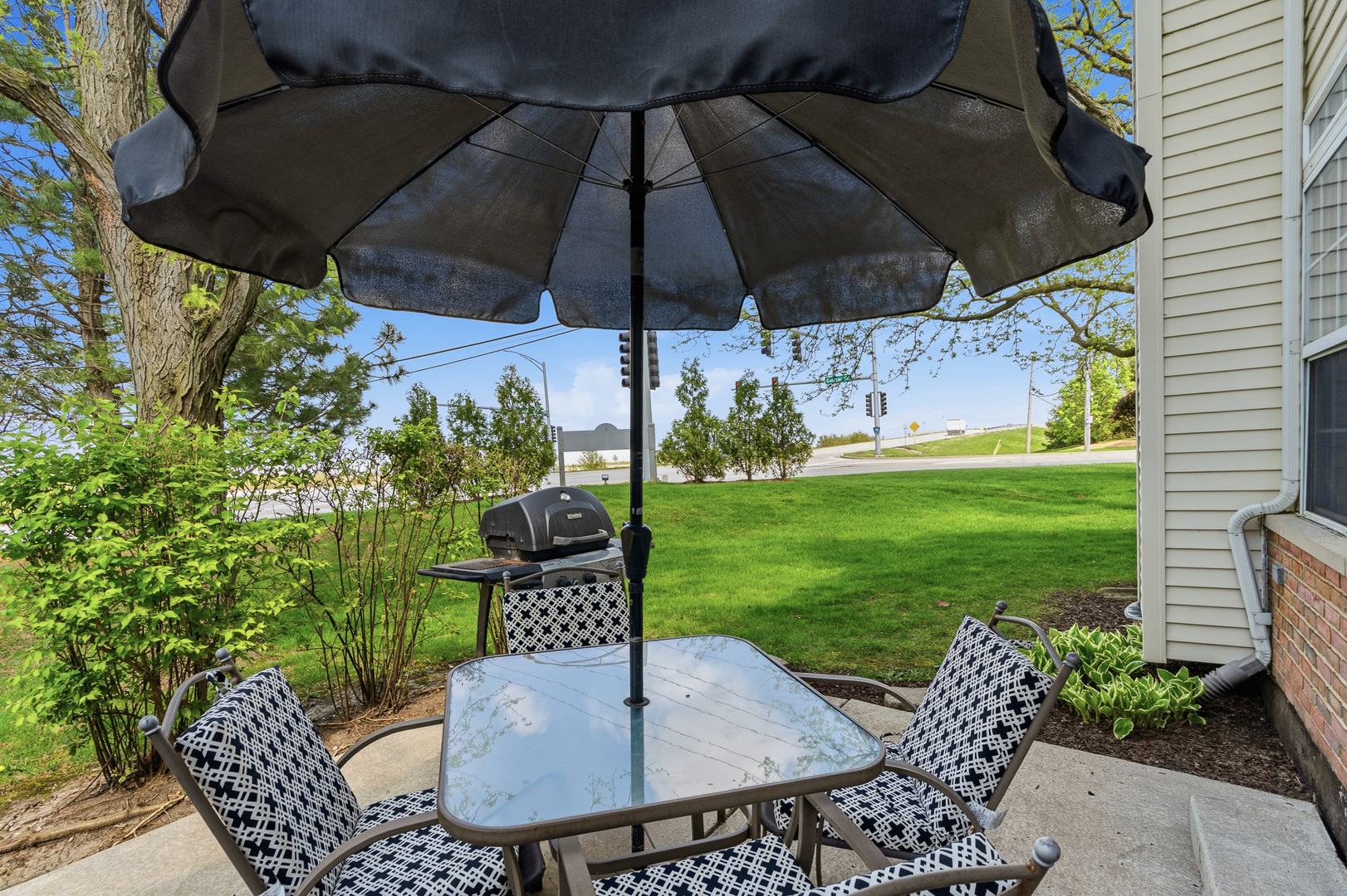 16719 South Sunset Ridge Court Lockport, IL 60441 - Photo 26 of 31 a patio with a table and chairs and a umbrella