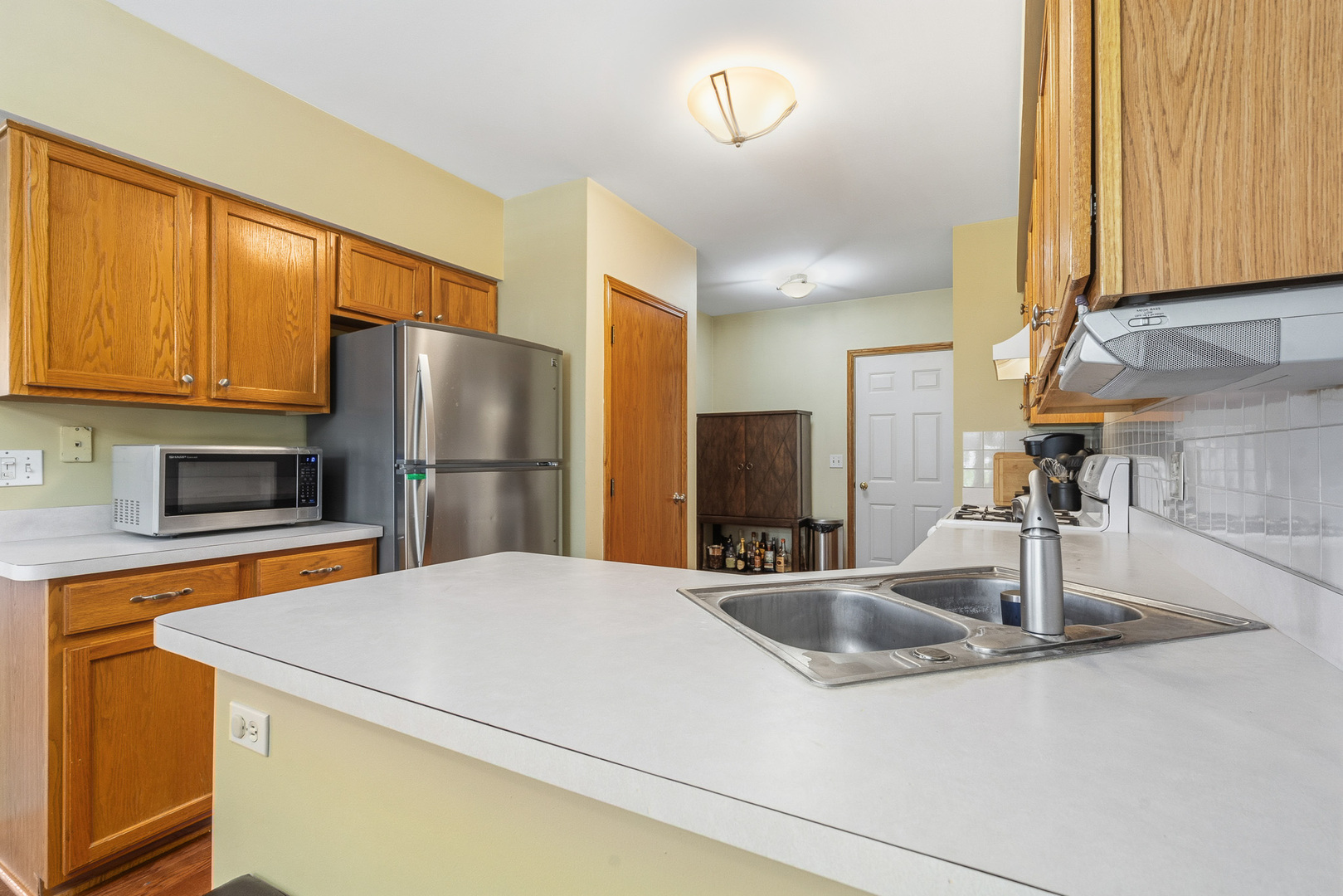 16719 South Sunset Ridge Court Lockport, IL 60441 - Photo 4 of 31 a kitchen with stainless steel appliances a sink and a refrigerator